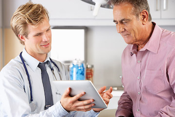A doctor and a patient looking at an iPad together